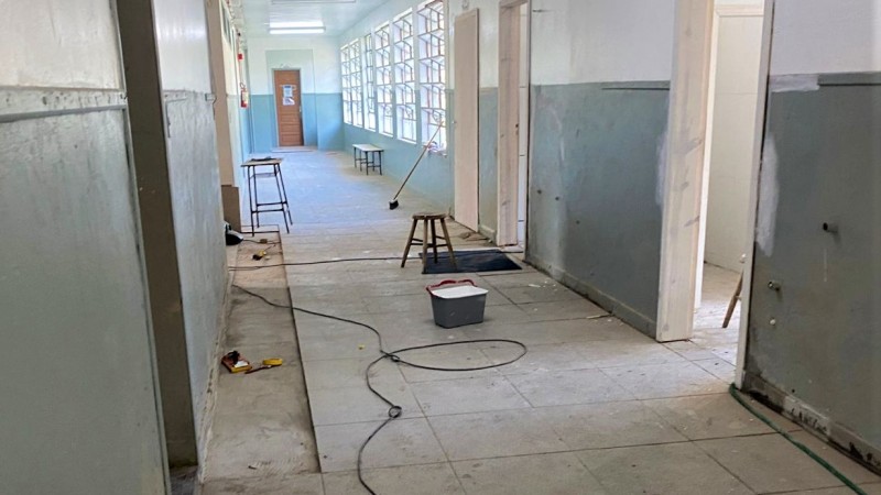 Foto de um corredor vazio do Anexo 1 citado no texto, na qual se pode observar o piso novo em processo de colocação.
