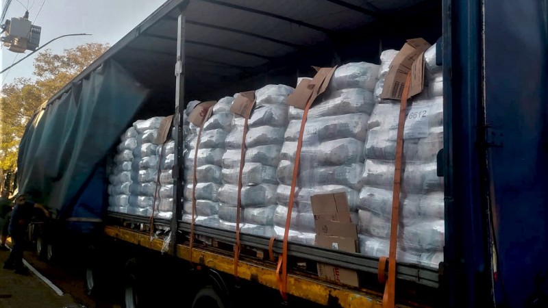 Foto da carroceria ba&uacute; de uma caminh&atilde;o repleta de cestas b&aacute;sicas.