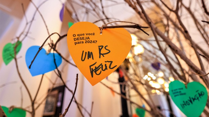 Close de um coração de papel afixado na Árvore do Futuro no qual se lê: O que você deseja para 2024? Um RS feliz.