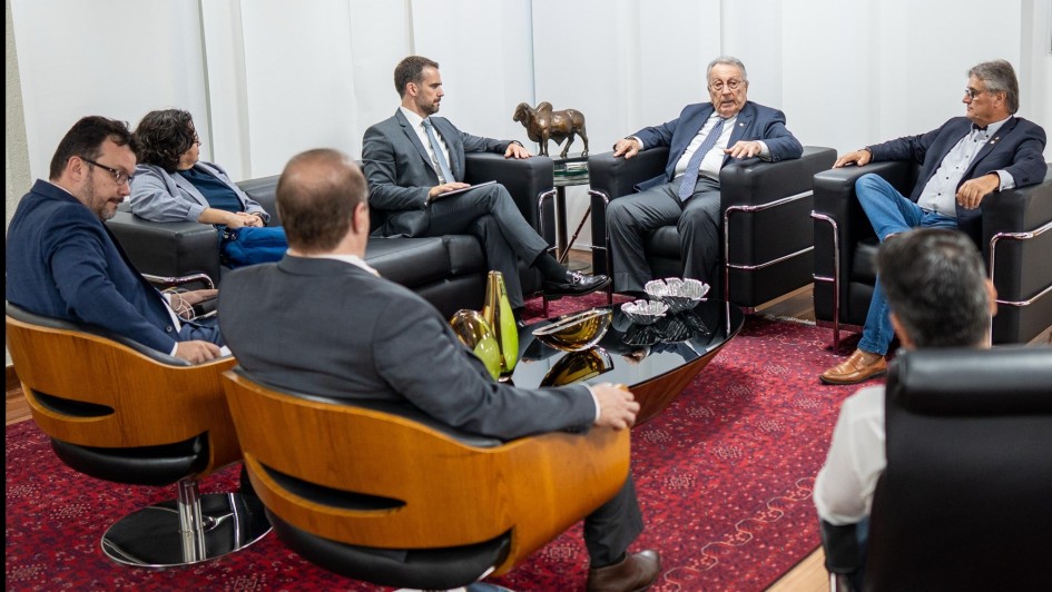 Imagem de Leite e outras seis pessoas sentadas em cadeiras e poltronas durante a reunião na CNA.