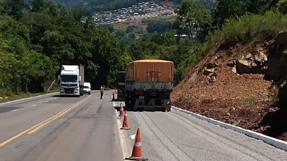 A imagem mostra dois caminh&otilde;es parados em uma rampa de escape ao lado direito da rodovia. No outro sentido, outro caminh&atilde;o est&aacute; passando. 