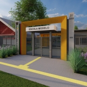 A imagem &eacute; uma reprodu&ccedil;&atilde;o de um projeto que mostra a entrada de uma escola com um p&oacute;rtico moderno em estrutura retangular amarela, onde est&aacute; escrita a identifica&ccedil;&atilde;o &ldquo;Escola Modelo&rdquo;. Um totem lateral exibe o bras&atilde;o estadual e a inscri&ccedil;&atilde;o &ldquo;Escola Estadual&rdquo;. O acesso &eacute; composto por cal&ccedil;adas cinzas com marca&ccedil;&otilde;es amarelas. H&aacute; canteiros com vegeta&ccedil;&atilde;o e flores nas laterais, e ao fundo aparecem pr&eacute;dios escolares com grades met&aacute;licas e um gin&aacute;sio de formato curvo.
